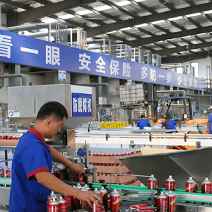 factory worker inspecting spray paint cans.jpg